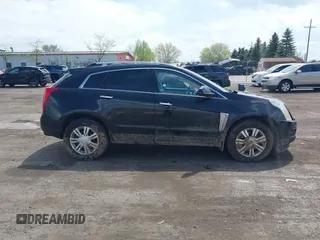 2014 Cadillac SRX Luxury Collection z VIN 3GYFNEE32ES659705, wystawiony jako IAAI lot #42148269 z przebiegiem 140 560 mil mil oraz . Historia ofert i sprzedaży dostępna na DreamBid. Obrazek 13.