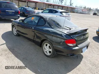 2000 Hyundai Tiburon z VIN KMHJG35F5YU191588, wystawiony jako IAAI lot #41934653 z przebiegiem 161 590 mil mil oraz . Historia ofert i sprzedaży dostępna na DreamBid. Obrazek 3.