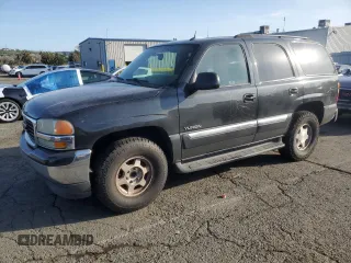 2005 GMC Yukon SLT with VIN 1GKEC13V95J163892, listed as a Copart auction lot 50243795 with 211,048 mi miles and Salvage Title. Bid and sale history available at carsss.com. Image 1.