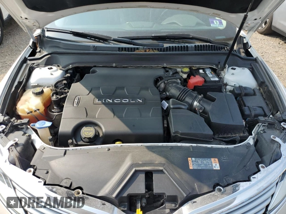 2015 Lincoln MKZ z VIN 3LN6L2GK9FR622783, wystawiony jako Copart lot #59892995 z przebiegiem 174 209 mil mil oraz Szkoda całkowita • Salvage title. Historia ofert i sprzedaży dostępna na DreamBid. Obrazek 11.