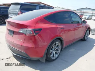 2023 Tesla Model Y Long Range z VIN 7SAYGAEE7PF691499, wystawiony jako IAAI lot #42038850 z przebiegiem 26 439 mil mil oraz . Historia ofert i sprzedaży dostępna na DreamBid. Obrazek 4.