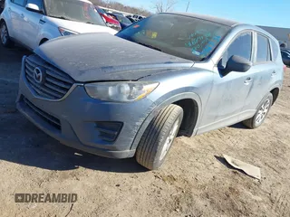 2016 Mazda CX-5 Sport with VIN JM3KE2BY3G0641895, listed as a IAAI auction lot 41689138 with 121,636 mi miles and . Bid and sale history available at DreamBid. Image 2.