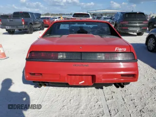 1988 Pontiac Fiero z VIN 1G2PE11R1JP219470, wystawiony jako Copart lot #77772864 z przebiegiem 94 011 mil mil oraz Szkody całkowita. Historia ofert i sprzedaży dostępna na DreamBid. Obrazek 6.