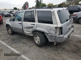 1997 Jeep Grand Cherokee Laredo with VIN 1J4GZ58S0VC771727, listed as a Copart auction lot 82233224 with 320,213 mi miles and Salvage Title. Bid and sale history available at carsss.com. Image 2.