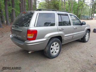 1999 Jeep Grand Cherokee Limited with VIN 1J4GW68N5XC684157, listed as a IAAI auction lot 42104283 with 164,506 mi miles. Bid and sale history available at carsss.com. Image 4.