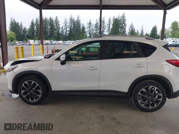 2016 Mazda CX-5 Grand Touring with VIN JM3KE2DYXG0675619, listed as a IAAI auction lot 42137144 with 106,262 mi miles and . Bid and sale history available at DreamBid. Image 14.