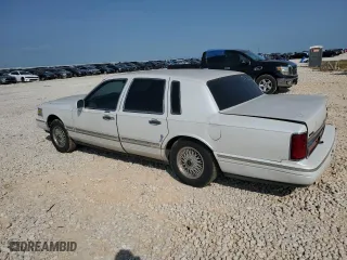 1997 Lincoln Town Car Signature with VIN 1LNLM82W9VY681894, listed as a Copart auction lot 71467034 with 129,142 mi miles and Salvage Title. Bid and sale history available at carsss.com. Image 2.
