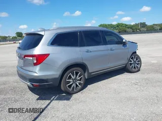 2021 Honda Pilot Touring 8-Passenger with VIN 5FNYF5H99MB041638, listed as a IAAI auction lot 42112915 with 33,230 mi miles and . Bid and sale history available at DreamBid. Image 4.
