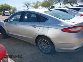 2014 Ford Fusion Titanium Hybrid with VIN 3FA6P0RUXER103516, listed as a IAAI auction lot 42004602 with 128,287 mi miles and . Bid and sale history available at carsss.com. Image 14.