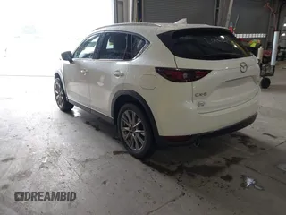 2020 Mazda CX-5 Grand Touring with VIN JM3KFADMXL0742038, listed as a IAAI auction lot 42292400 with 68,339 mi miles and . Bid and sale history available at DreamBid. Image 3.