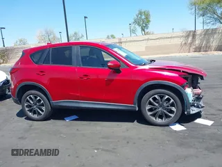 2016 Mazda CX-5 Grand Touring z VIN JM3KE2DY2G0660385, wystawiony jako IAAI lot #42101004 z przebiegiem 166 336 mil mil oraz . Historia ofert i sprzedaży dostępna na DreamBid. Obrazek 14.