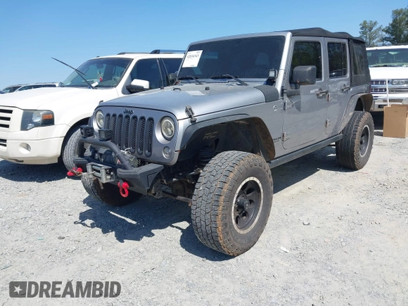 2014 Jeep Wrangler Unlimited Sport with VIN 1C4BJWDG4EL292421, listed as a IAAI auction lot 42034343 with 157,820 mi miles. Bid and sale history available at carsss.com. Image 2.