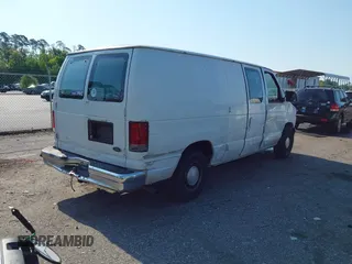 1999 Ford Econoline Cargo with VIN 1FTRE1420XHA34056, listed as a IAAI auction lot 41998411 with 236,267 mi miles. Bid and sale history available at carsss.com. Image 4.