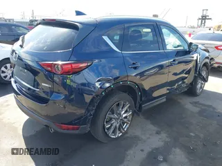 2020 Mazda CX-5 Grand Touring with VIN JM3KFADM6L1830093, listed as a IAAI auction lot 41699672 with 66,769 mi miles. Bid and sale history available at carsss.com. Image 4.