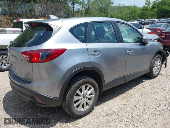2014 Mazda CX-5 Sport with VIN JM3KE2BEXE0329303, listed as a IAAI auction lot 42556908 with 127,836 mi miles and . Bid and sale history available at DreamBid. Image 4.