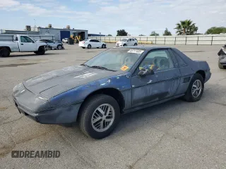 1985 Pontiac Fiero z VIN 1G2PM37R2FP239143, wystawiony jako Copart lot #45717405 z przebiegiem Nie podano mil oraz Tytuł czysty. Historia ofert i sprzedaży dostępna na DreamBid. Obrazek 1.