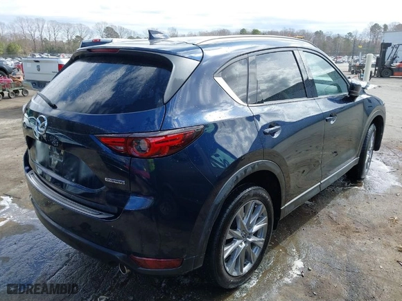 2021 Mazda CX-5 Grand Touring with VIN JM3KFADM1M1356538, listed as a IAAI auction lot 41723485 with 91,925 mi miles. Bid and sale history available at carsss.com. Image 4.
