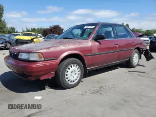 1991 Toyota Camry DLX z VIN 4T1SV21E7MU414824, wystawiony jako Copart lot #61604434 z przebiegiem 170 867 mil mil oraz Szkoda całkowita • Salvage title. Historia ofert i sprzedaży dostępna na DreamBid. Obrazek 1.