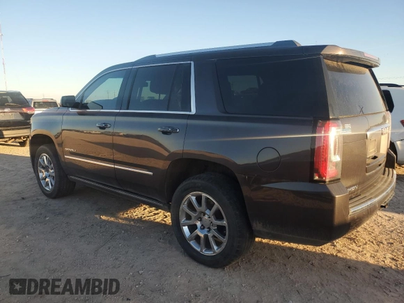2015 GMC Yukon Denali with VIN 1GKS1CKJ7FR132677, listed as a Copart auction lot 82118584 with 144,798 mi miles and Salvage Title. Bid and sale history available at carsss.com. Image 2.