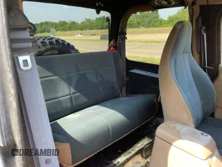 1999 Jeep Wrangler Sahara with VIN 1J4FY49S5XP496486, listed as a Copart auction lot 77263014 with 128,498 mi miles and Clean Title. Bid and sale history available at carsss.com. Image 6.