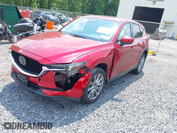 2021 Mazda CX-5 Grand Touring with VIN JM3KFBDM3M0434569, listed as a IAAI auction lot 42422349 with 25,924 mi miles and . Bid and sale history available at DreamBid. Image 2.