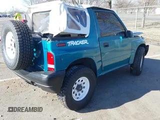 1996 Chevrolet Tracker z VIN 2CNBE1866T6936852, wystawiony jako IAAI lot #41812790 z przebiegiem 72 762 mil mil oraz . Historia ofert i sprzedaży dostępna na DreamBid. Obrazek 4.