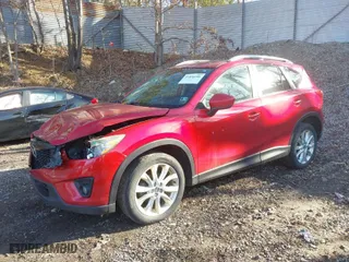 2014 Mazda CX-5 Grand Touring with VIN JM3KE2DY1E0380423, listed as a IAAI auction lot 41854206 with 129,763 mi miles. Bid and sale history available at carsss.com. Image 2.