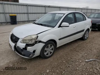2009 Kia Rio LX with VIN KNADE223196462449, listed as a Copart auction lot 86861454 with 133,137 mi miles and Salvage Title. Bid and sale history available at carsss.com. Image 1.