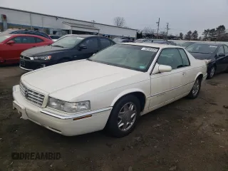 1999 Cadillac Eldorado z VIN 1G6EL12Y5XU600699, wystawiony jako Copart lot #88164505 z przebiegiem 140 075 mil mil oraz Szkoda całkowita • Salvage title. Historia ofert i sprzedaży dostępna na DreamBid. Obrazek 1.