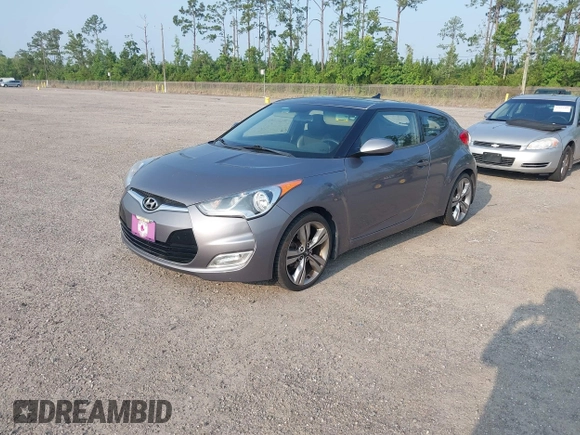2012 Hyundai Veloster w/Gray Int z VIN KMHTC6AD1CU081754, wystawiony jako IAAI lot #42421889 z przebiegiem 99 593 mil mil oraz . Historia ofert i sprzedaży dostępna na DreamBid. Obrazek 2.