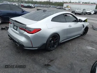 2022 BMW M4 Competition with VIN WBS33AZ04NCJ20184, listed as a IAAI auction lot 41205528 with 25,571 mi miles. Bid and sale history available at carsss.com. Image 4.