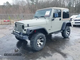 1999 Jeep Wrangler Sahara with VIN 1J4FY49S0XP480017, listed as a IAAI auction lot 41642577 with 154,068 mi miles. Bid and sale history available at carsss.com. Image 2.