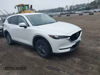2021 Mazda CX-5 Touring with VIN JM3KFBCM1M1446313, listed as a IAAI auction lot 41930330 with 28,610 mi miles. Bid and sale history available at carsss.com. Image 1.
