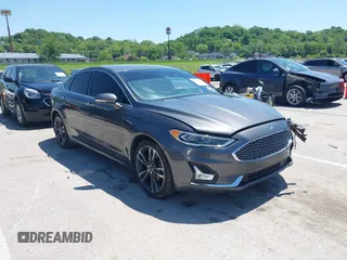 2020 Ford Fusion Titanium z VIN 3FA6P0K96LR173971, wystawiony jako IAAI lot #42232469 z przebiegiem 82 474 mil mil oraz . Historia ofert i sprzedaży dostępna na DreamBid. Obrazek 1.