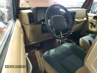 2002 Jeep Wrangler Sahara z VIN 1J4FA59S62P751858, wystawiony jako Copart lot #56638165 z przebiegiem 270 770 mil mil oraz Szkoda całkowita • Salvage title. Historia ofert i sprzedaży dostępna na DreamBid. Obrazek 8.