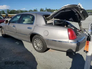 1999 Lincoln Town Car Signature z VIN 1LNHM82W7XY626305, wystawiony jako Copart lot #58009475 z przebiegiem Nie podano mil oraz Szkoda całkowita • Salvage title. Historia ofert i sprzedaży dostępna na DreamBid. Obrazek 2.