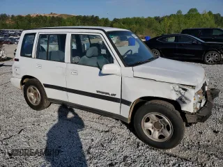 1997 Geo Tracker LSi z VIN 2CNBE1360V6927915, wystawiony jako Copart lot #53469605 z przebiegiem 119 413 mil mil oraz Szkody całkowita. Historia ofert i sprzedaży dostępna na DreamBid. Obrazek 4.