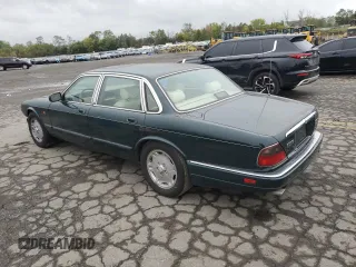 1996 Jaguar XJ with VIN SAJHX1741TC758740, listed as a Copart auction lot 73377914 with 140,964 mi miles and Salvage title. Bid and sale history available at DreamBid. Image 2.