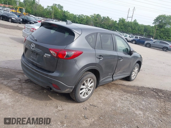 2014 Mazda CX-5 Touring z VIN JM3KE4CY2E0348500, wystawiony jako IAAI lot #42318155 z przebiegiem 182 616 mil mil oraz . Historia ofert i sprzedaży dostępna na DreamBid. Obrazek 4.
