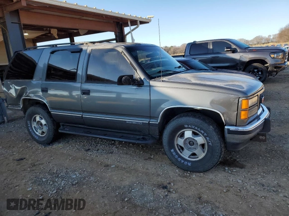 1999 GMC Yukon with VIN 1GKEK13R3XJ750307, listed as a Copart auction lot 84728104 with 212,879 mi miles and Salvage Title. Bid and sale history available at carsss.com. Image 4.