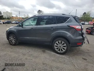 2017 Ford Escape Titanium with VIN 1FMCU0J98HUF09588, listed as a Copart auction lot 48988765 with 101,887 mi miles and Salvage Title. Bid and sale history available at DreamBid. Image 2.