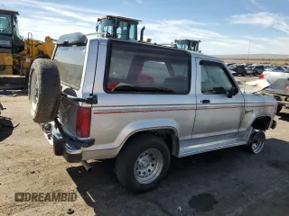 1988 Ford Bronco z VIN 1FMCU14T2JUA39593, wystawiony jako Copart lot #76556764 z przebiegiem Nie podano mil oraz Szkoda całkowita • Salvage title. Historia ofert i sprzedaży dostępna na DreamBid. Obrazek 3.