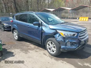 2018 Ford Escape SE z VIN 1FMCU9GD2JUB94325, wystawiony jako IAAI lot #41963444 z przebiegiem 103 282 mil mil oraz . Historia ofert i sprzedaży dostępna na DreamBid. Obrazek 1.