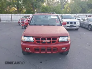 2001 Isuzu Rodeo S z VIN 4S2CK58W414308980, wystawiony jako IAAI lot #42496432 z przebiegiem 166 360 mil mil oraz . Historia ofert i sprzedaży dostępna na DreamBid. Obrazek 6.