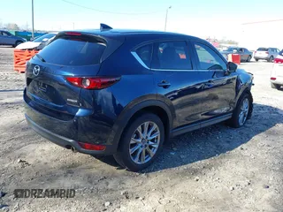 2021 Mazda CX-5 Grand Touring with VIN JM3KFADM5M0428279, listed as a IAAI auction lot 41747175 with 49,579 mi miles. Bid and sale history available at carsss.com. Image 4.