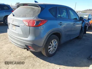 2016 Mazda CX-5 Sport with VIN JM3KE2BY3G0641895, listed as a IAAI auction lot 41689138 with 121,636 mi miles and . Bid and sale history available at DreamBid. Image 4.