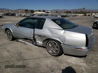 1999 Cadillac Eldorado z VIN 1G6EL12Y0XU604529, wystawiony jako Copart lot #77620004 z przebiegiem 246 032 mil mil oraz Szkoda całkowita • Salvage title. Historia ofert i sprzedaży dostępna na DreamBid. Obrazek 2.