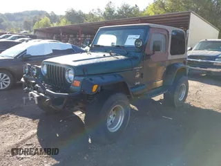 2000 Jeep Wrangler Sahara with VIN 1J4FA59S2YP734290, listed as a IAAI auction lot 41874866 with 201,036 mi miles. Bid and sale history available at carsss.com. Image 2.