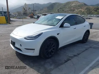 2021 Tesla Model Y Long Range with VIN 5YJYGDEE0MF069451, listed as a IAAI auction lot 41482649 with 55,542 mi miles. Bid and sale history available at carsss.com. Image 2.