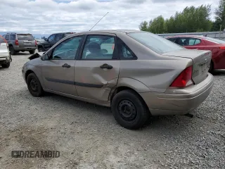 2004 Ford Focus LX with VIN 1FAFP33P24W148563, listed as a Copart auction lot 63869755 with 142,243 mi miles and Salvage title. Bid and sale history available at DreamBid. Image 2.